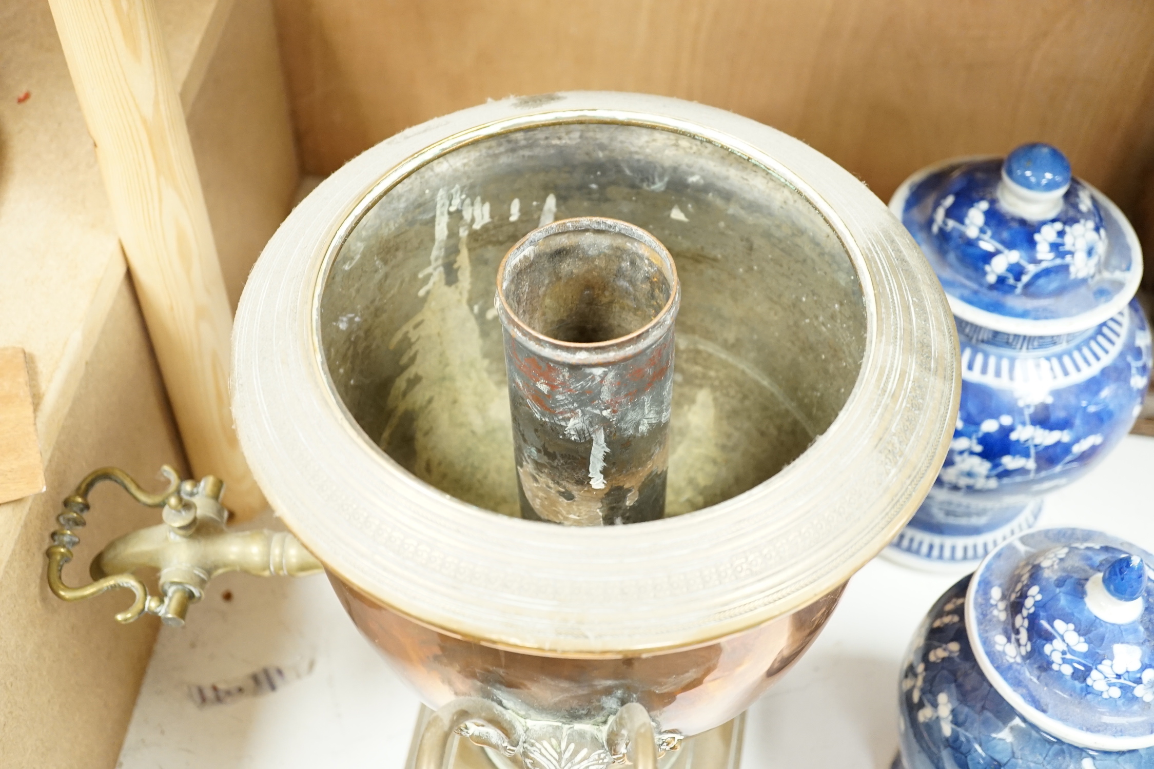 A copper tea urn with brass spigot tap and handles, 44cm